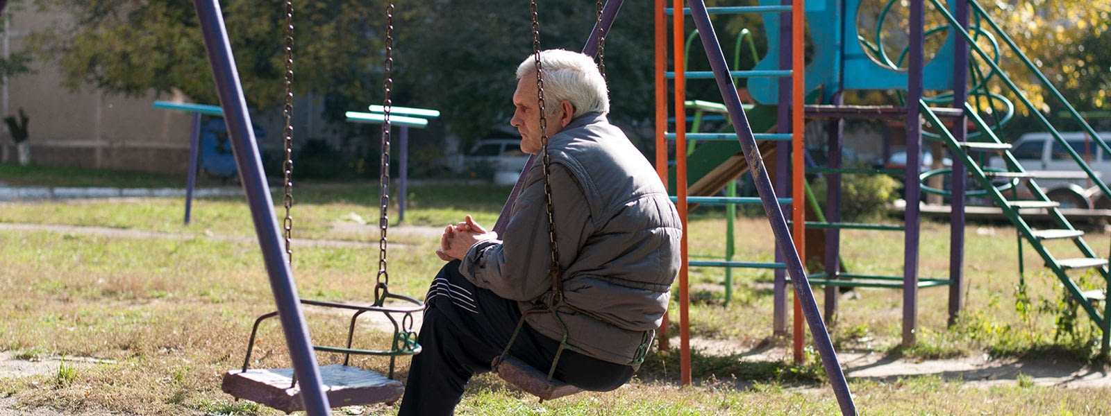 older man alone on swing